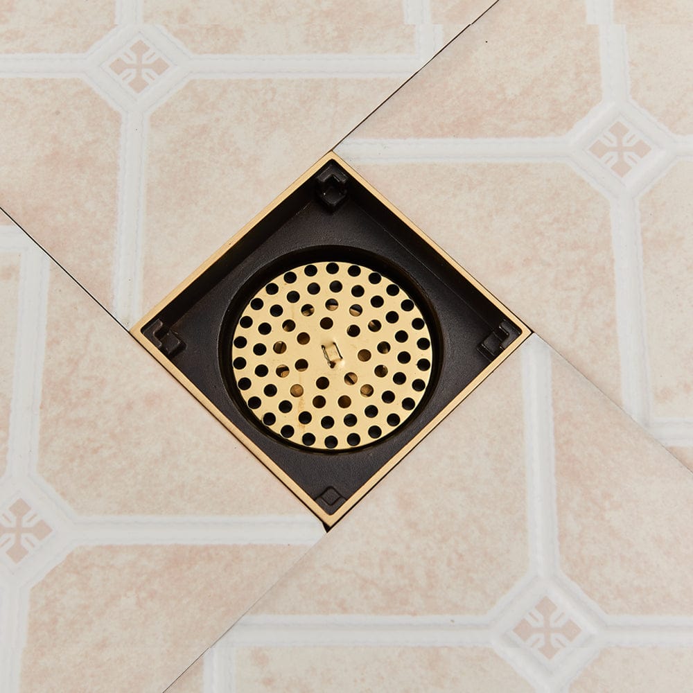 Sifon de pardoseala antimiros, cu iesire verticala, diametru ramă 100 mm, diametru scurgere 38 mm, doua fețe suport fixare placa gresie, auriu nichelat, cod 1521