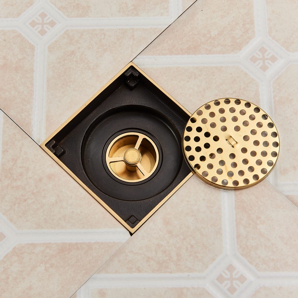 Sifon de pardoseala antimiros, cu iesire verticala, diametru ramă 100 mm, diametru scurgere 38 mm, doua fețe suport fixare placa gresie, auriu nichelat, cod 1521